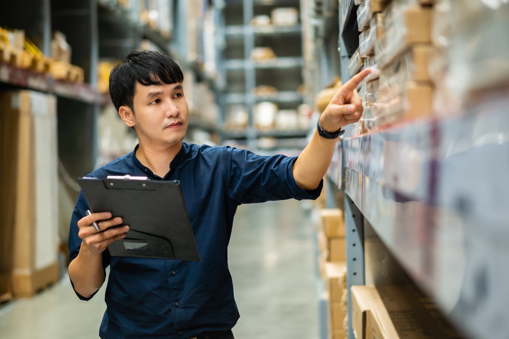 young-man-worker-holding-clipboard-checking-inventory-warehouse-store (1)